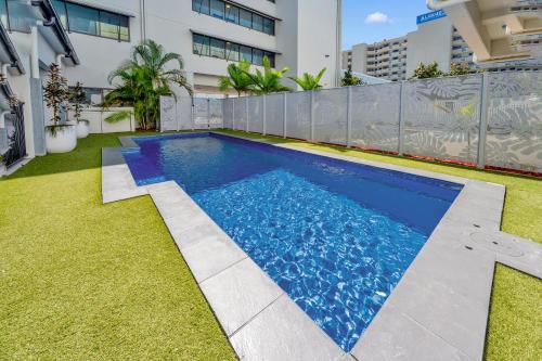 a swimming pool in the backyard of a building at The Palmer Collective in Townsville