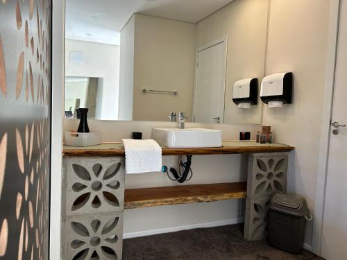 a bathroom with a sink and a mirror at Fazenda Boutique Vila dos Eucaliptos in Atibaia