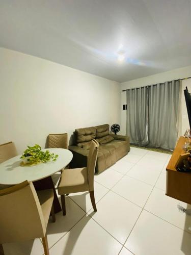 a living room with a table and a couch at Casa para a COP 30 in Castanhal