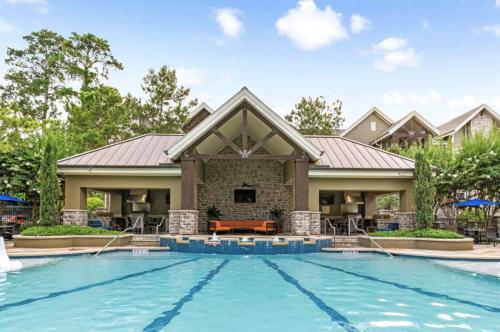 a house with a swimming pool in front of a house at Resort Style Apartment/Home - The Woodlands in The Woodlands