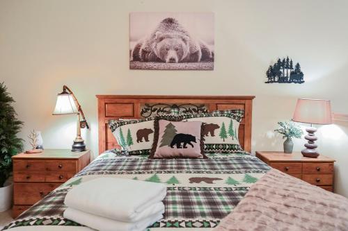 a bedroom with a bed with a blanket and pillows at The Hidden Moose in Brian Head