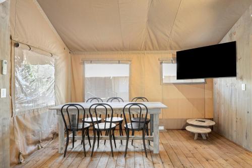 a dining room with a table and chairs in a tent at BIG4 Yarra Valley Park Lane Holiday Park in Healesville