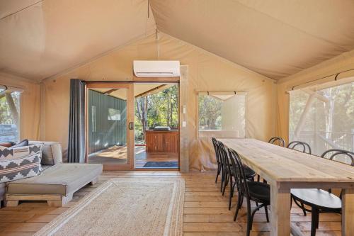 a tent with a table and chairs and a couch at BIG4 Yarra Valley Park Lane Holiday Park in Healesville