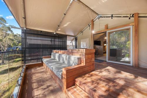 a porch with a couch on a wooden deck at BIG4 Yarra Valley Park Lane Holiday Park in Healesville