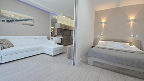a living room with a bed and a couch at Gardenia Sea Side MARTINA 1 Dziwnów in Dziwnów