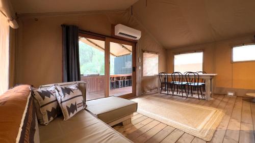 a living room with a couch and a balcony at BIG4 Yarra Valley Park Lane Holiday Park in Healesville