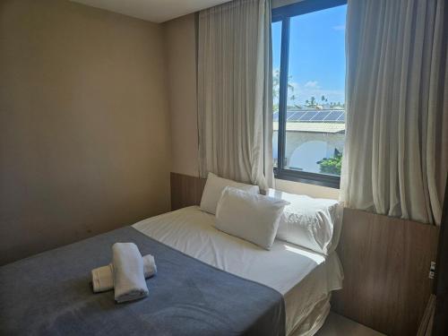 Postel nebo postele na pokoji v ubytování Viva Muro Alto no Cais 208