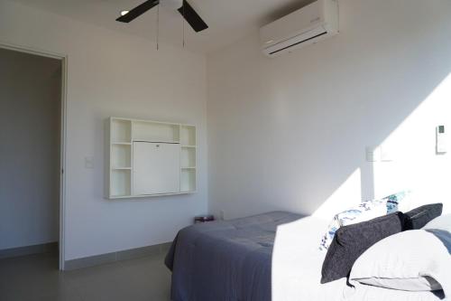a white bedroom with a bed and a window at Modern, with Ocean and Mountain View in Puerto Vallarta