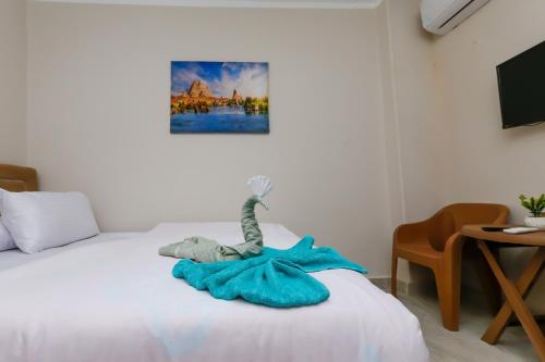 a bedroom with a bed with a stuffed animal on it at three pyramids view & jacuzii in Cairo