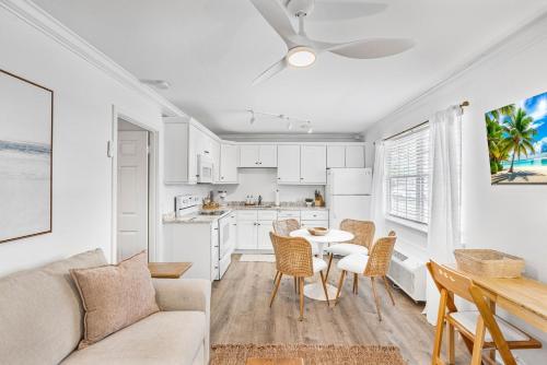 a living room and kitchen with a couch and a table at Barefoot Boho- Beach bungalow on Anna Maria Island in Bradenton Beach