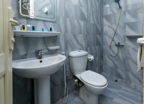 a bathroom with a toilet and a sink at Giza pyramids view & jacuzii in Cairo