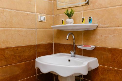 a bathroom with a white sink and a mirror at Giza pyramids view & jacuzii in Cairo