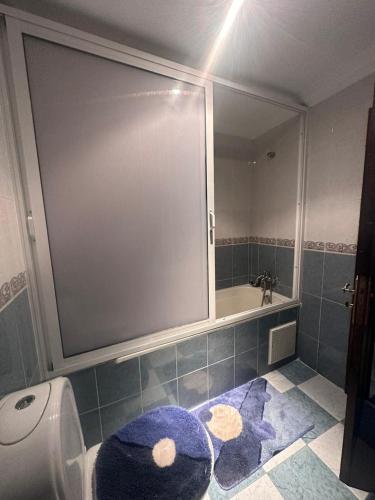 a bathroom with a toilet and a sink and a mirror at La gironde family apartment in Casablanca