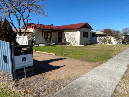 a house with a sign in front of it at Holbrook Haven - Bed and Breakfast in Holbrook