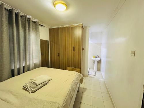 a bedroom with a bed with two towels on it at Fancy Homes Bungoma in Bungoma