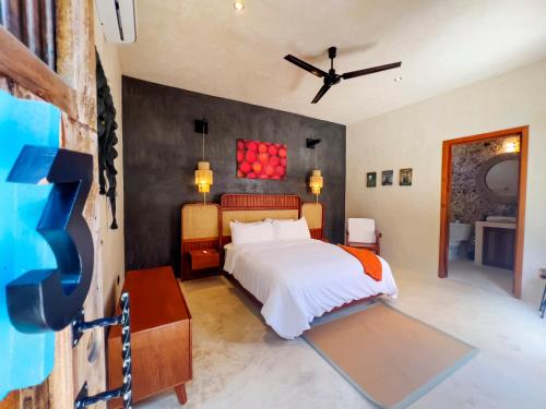 a bedroom with a bed and a tv in it at Casona Tres Culturas,steps away from the Convent in Izamal