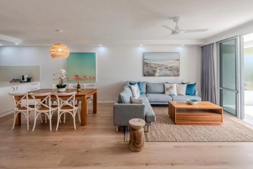 a living room with a couch and a table at Lagoon Apartments on Hamilton Island by HIHA in Hamilton Island