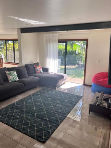 a living room with a couch and a rug at Atupa Holiday Home in Rarotonga