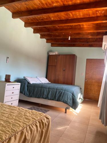 a bedroom with a bed and a wooden ceiling at La Amarilla in Santa María