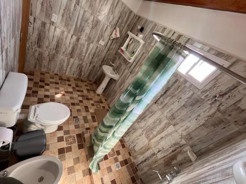 a bathroom with a shower with a shower curtain at La Amarilla in Santa María