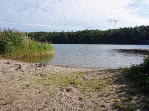 a body of water with trees in the background at 2 person holiday home in FäRENTUNA in Kungsberga