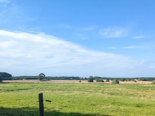 a fence in the middle of a field at 6 person holiday home in Gram in Gram