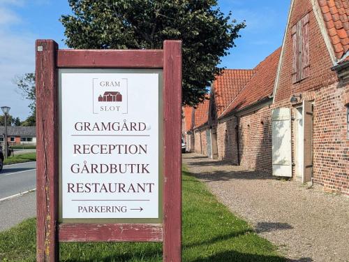 a sign in front of a brick building at 6 person holiday home in Gram in Gram