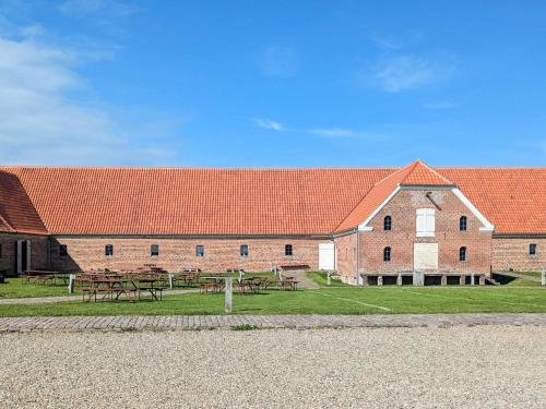 a large brick building with picnic tables in front of it at 6 person holiday home in Gram in Gram