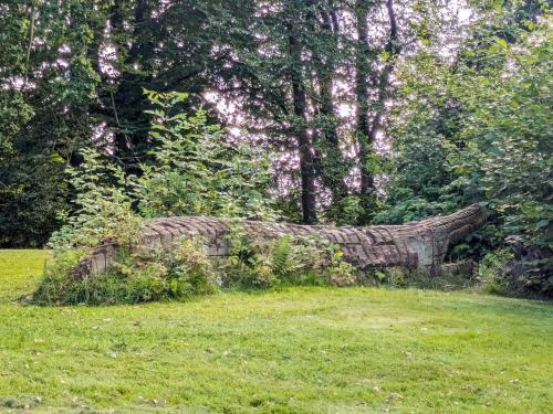 an old stone wall in a field of grass at 6 person holiday home in Gram in Gram