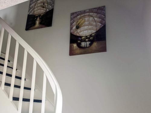 three pictures hanging on a wall above a staircase at 6 person holiday home in Gram in Gram