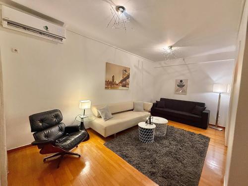 a living room with a couch and a chair at Central Glyfada 2BR Apartment in Athens
