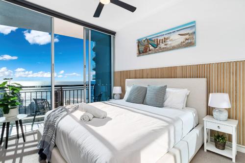 a bedroom with a large bed and a balcony at 'Skyline Oasis' by Inn Paradise in Gold Coast