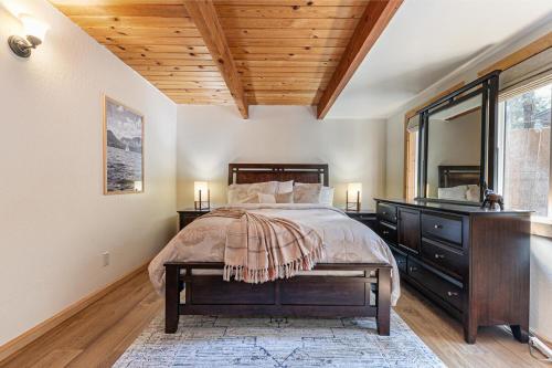 a bedroom with a bed with a dresser and a window at Retreat with Private Hot Tub steps North Lake Tahoe in Carnelian Bay