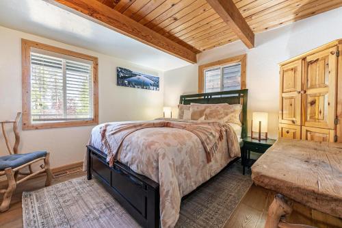 a bedroom with a bed and a wooden ceiling at Retreat with Private Hot Tub steps North Lake Tahoe in Carnelian Bay