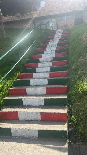 a set of stairs with red white and green at Acogedor y económico in Bogotá
