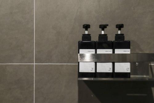 a row of bottles sitting on a counter in a bathroom at Brown Dot Hotel Hot Spring Yuseong in Daejeon