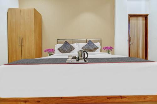 a bedroom with a large white bed with at Townhouse Ekana Inn in Vibhuti Khand