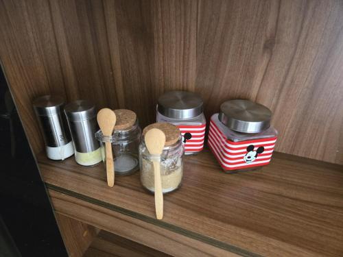 a wooden shelf with spices and spoons on it at Coban Apartmento in Cobán