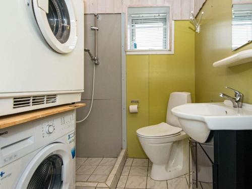 a bathroom with a washing machine and a sink at 4 person holiday home in Rønde-By Traum in Rønde