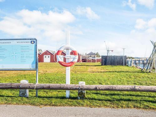 a sign sitting next to a bench in a field at 5 person holiday home in Højslev-By Traum in Højslev