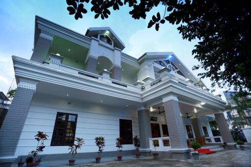a large white building with aventh floor at Sylvan Premium Guest House in Sylhet
