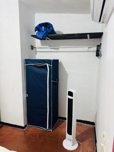 a small blue refrigerator in a room with a shelf at Casa Inteligente Anys in Tampico