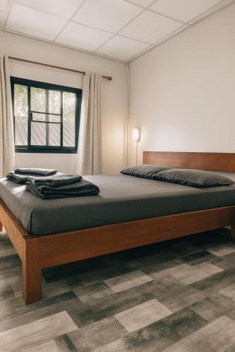 a bedroom with a large bed in a room at PaiPaiHostel in Pai