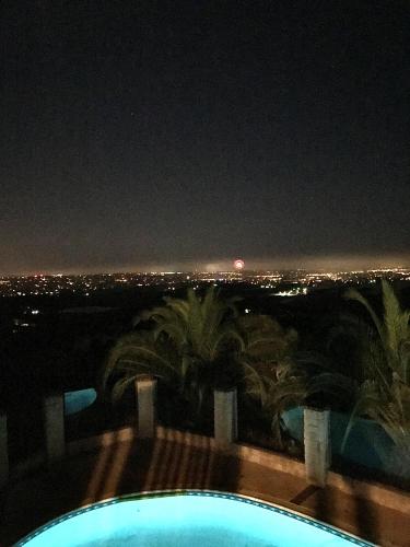 a view of the city at night from a swimming pool at Vintoca Luxury Honeymoon Suite Farm Retreat in Oceanside