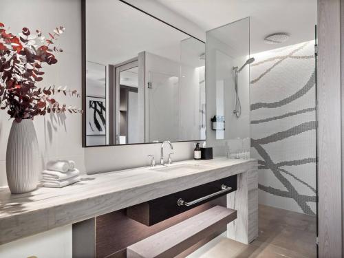 a bathroom with a sink and a large mirror at Samphire Chalet Banksia - A Serene Natural Beauty in Geographe