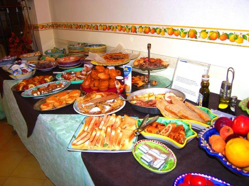 a buffet with many plates of food on a table at Locanda Degli Agrumi in Conca dei Marini