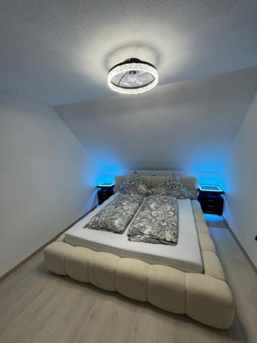 a bed in a room with a blue light at Ays-SPA, Whirlpool & Sauna in Iserlohn