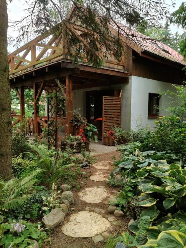 a house with a pathway in front of it at Dziki brzeg Jezioraka in Plajny