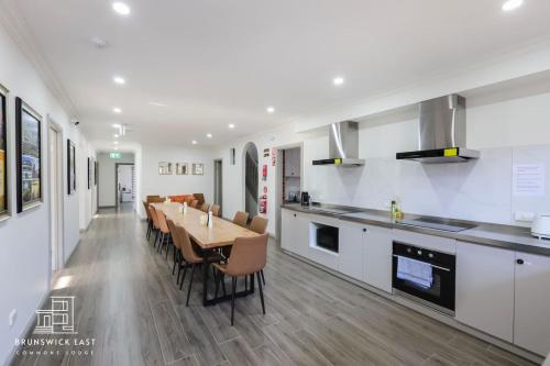 a kitchen and dining room with a table and chairs at 201 Chic Queen BR with Fast WiFi - Brunswick East in Melbourne