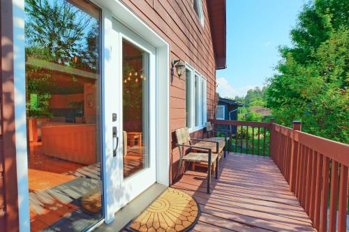 a porch with a sliding glass door on a house at LAuberge des Collines Escape for Two in Wakefield